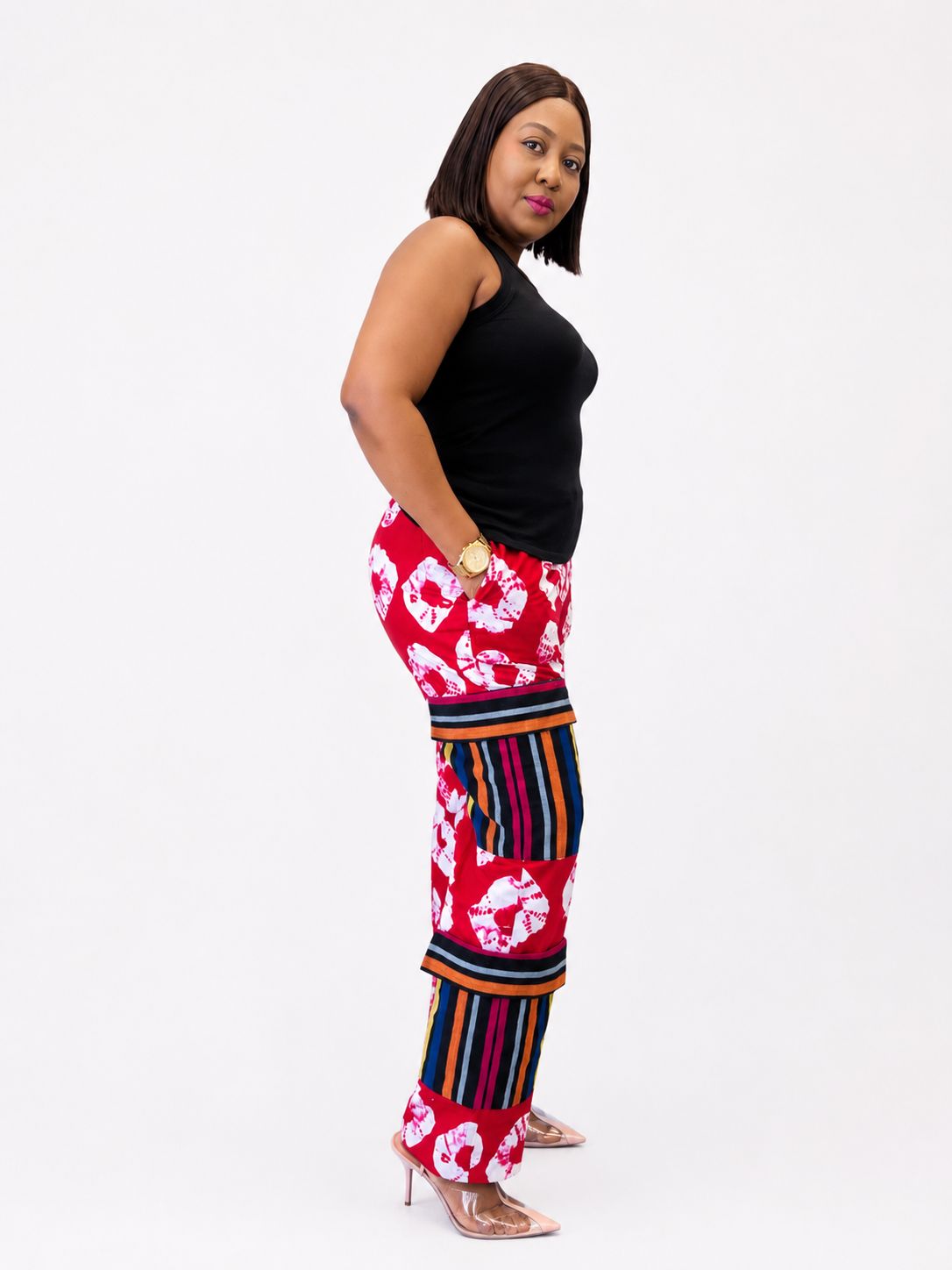 Side profile view of red shibori and striped tiered pants in 100% cotton