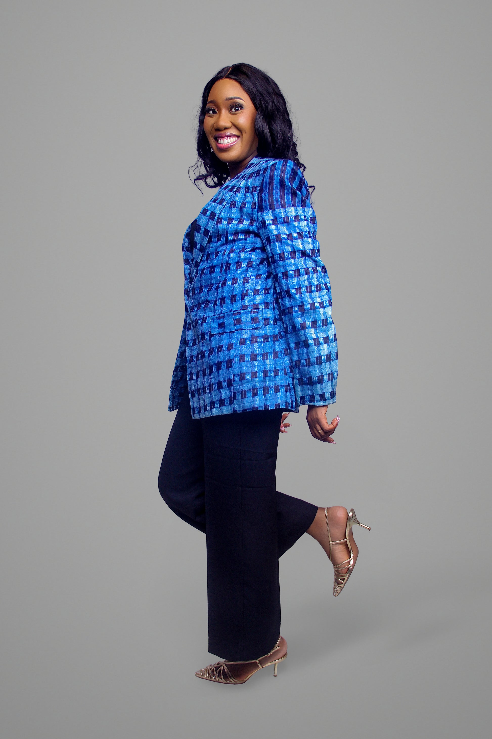 Side profile view of a woman wearing a structured blue geometric grid print cotton blazer