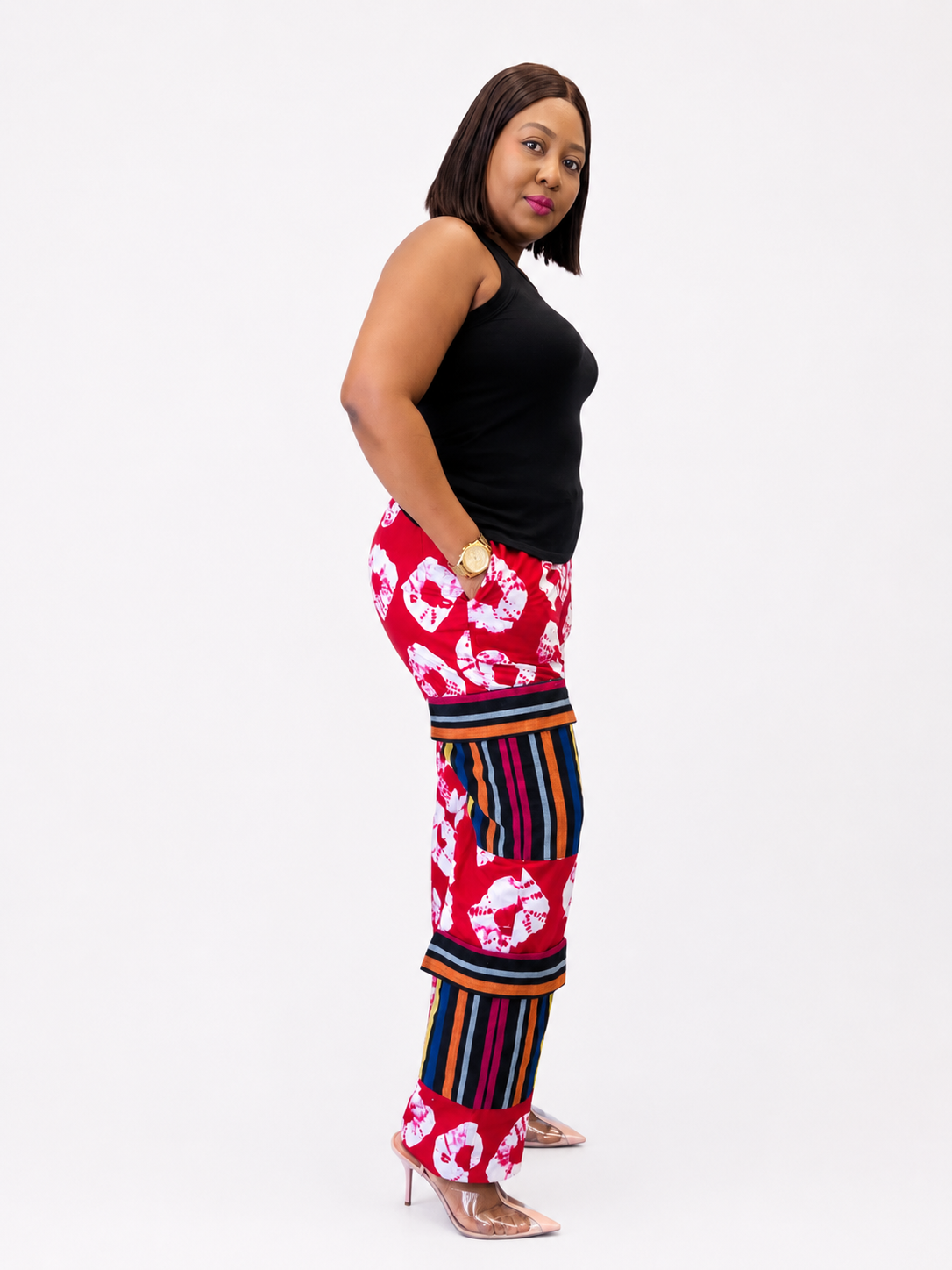 Side profile of red shibori and striped tiered pants showing the multi-patterned panel design