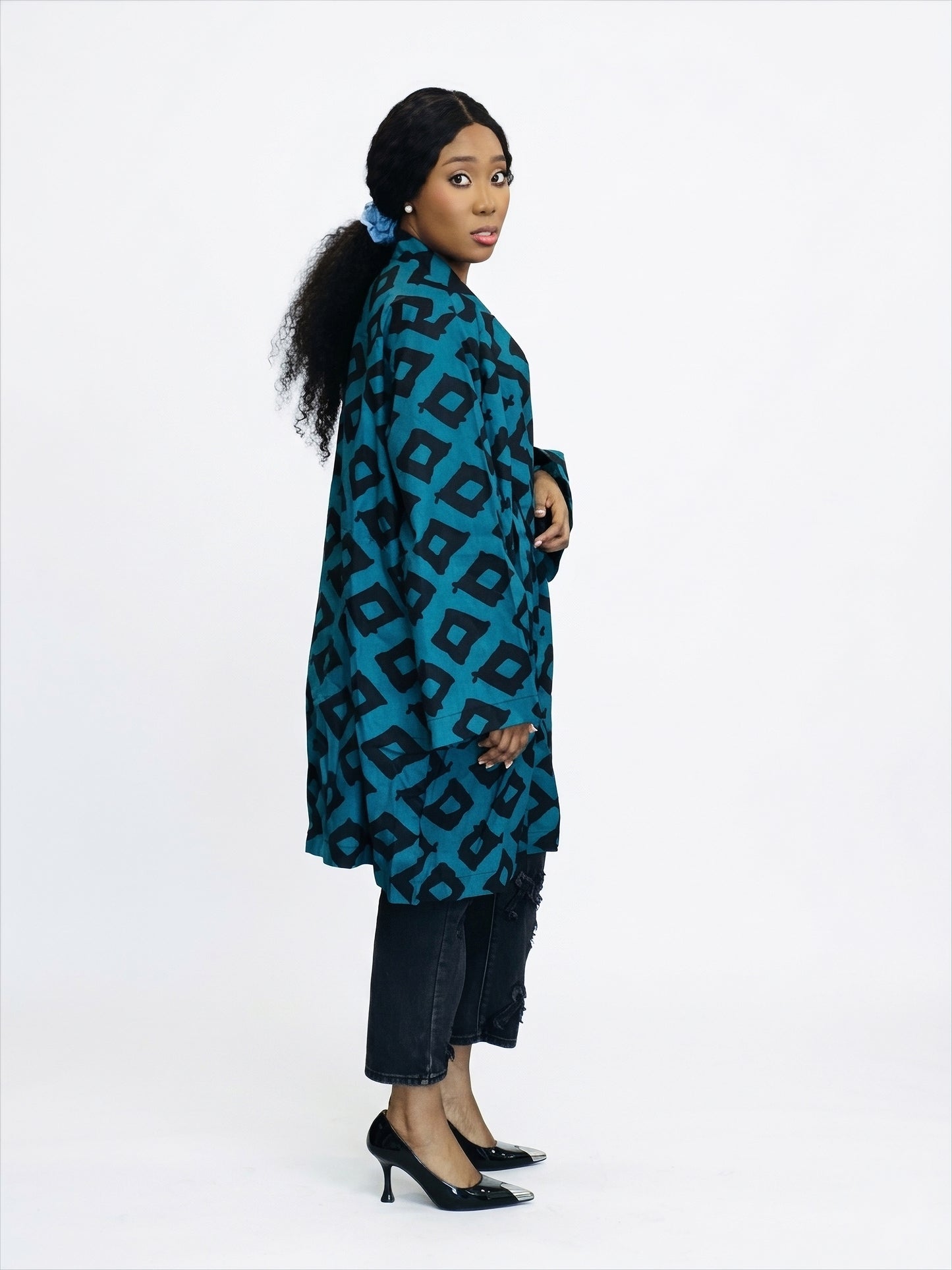 Profile view of geometric print kimono jacket emphasizing the structured silhouette