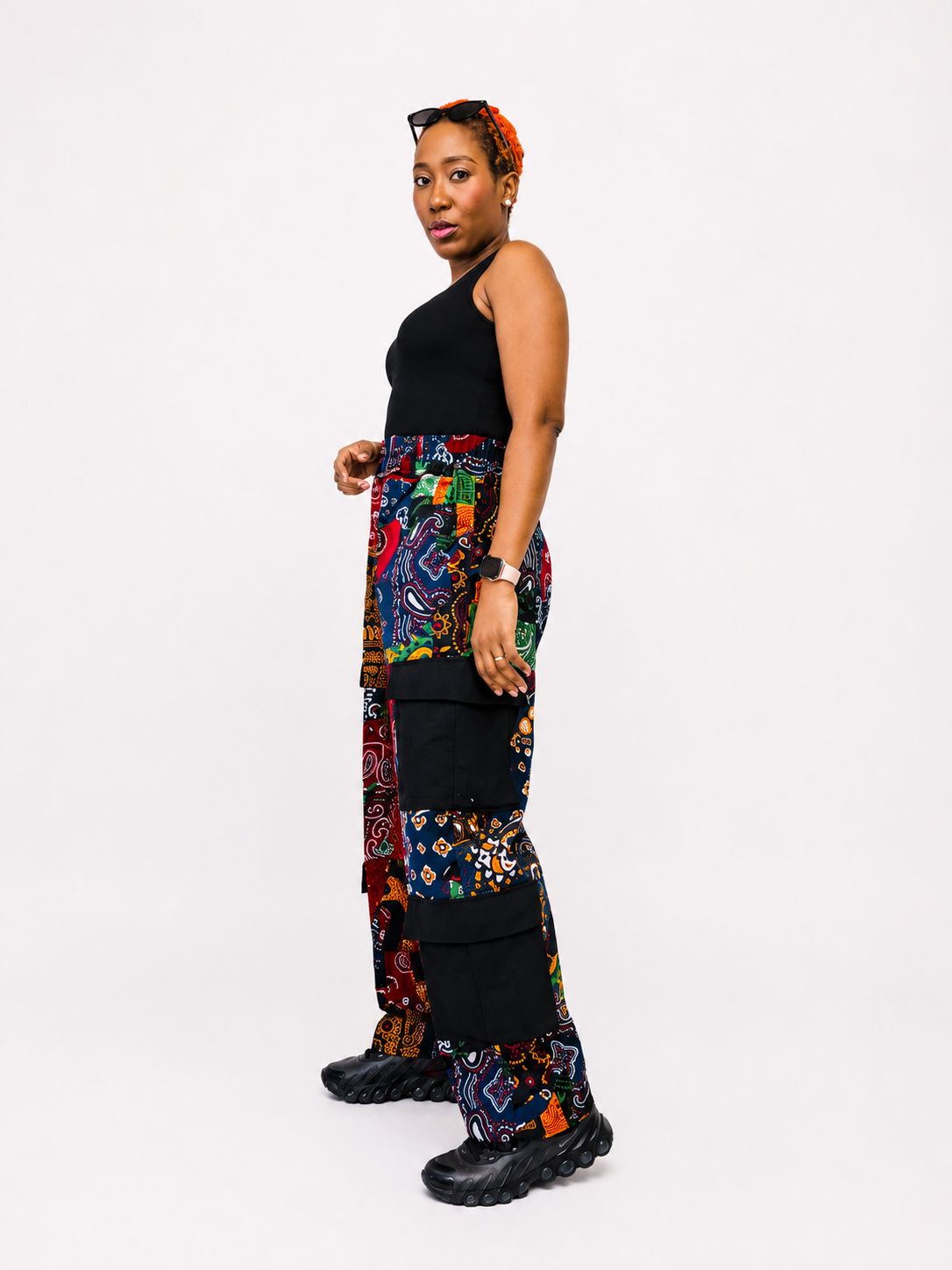 Side profile view highlighting the utility pocket placement on the patterned cargo trousers