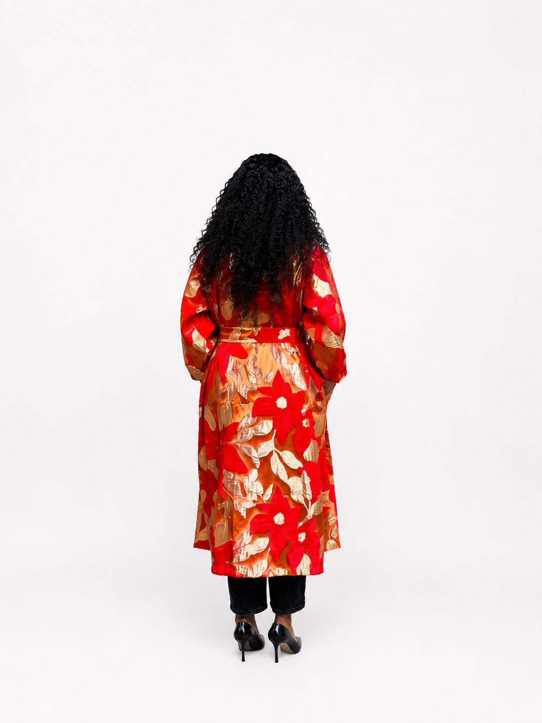 Back view of a woman wearing a red and gold floral brocade kimono coat, showing the length and pattern.