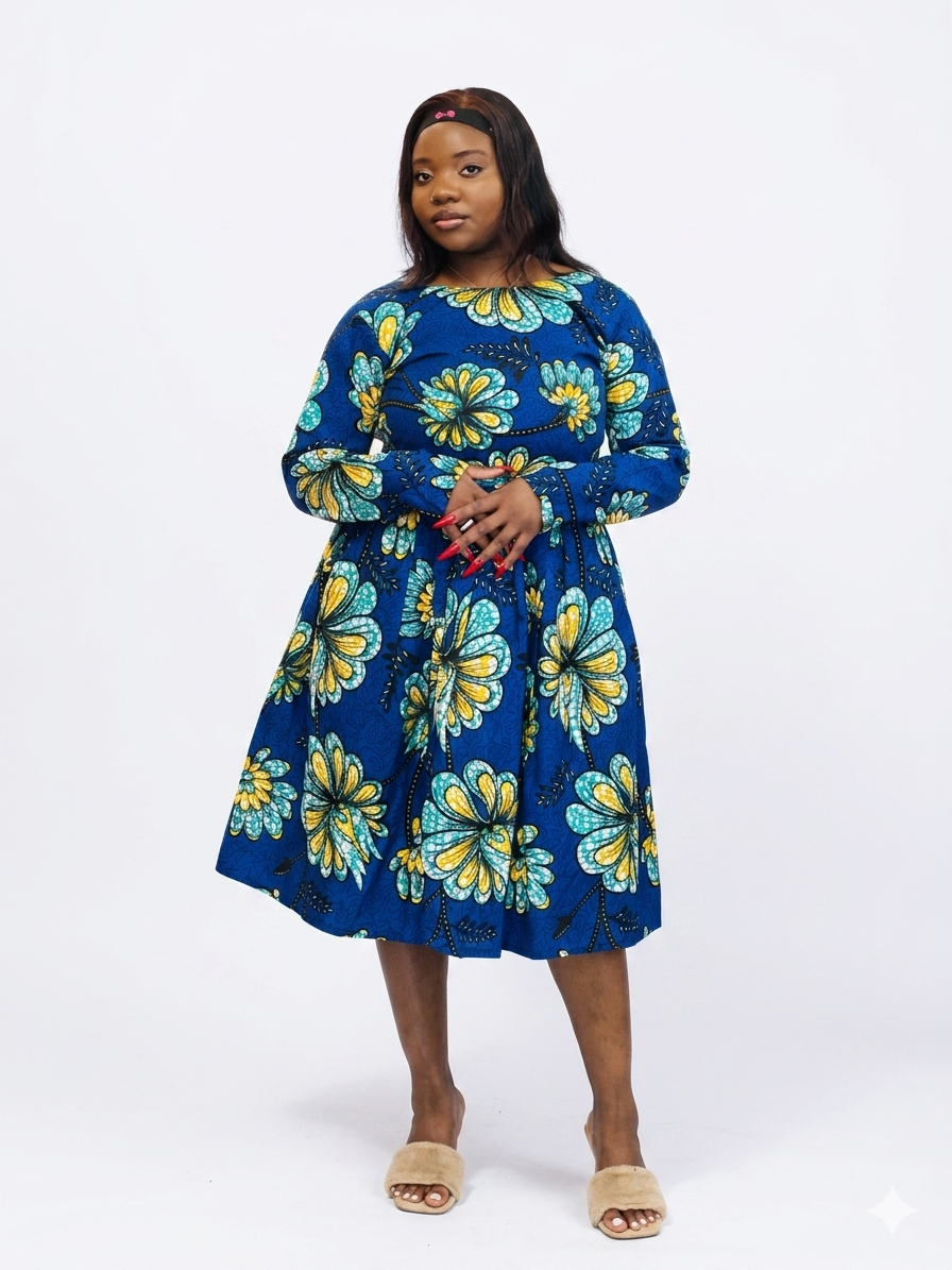 A long sleeve midi dress in a bold blue print with large yellow and teal flower patterns.