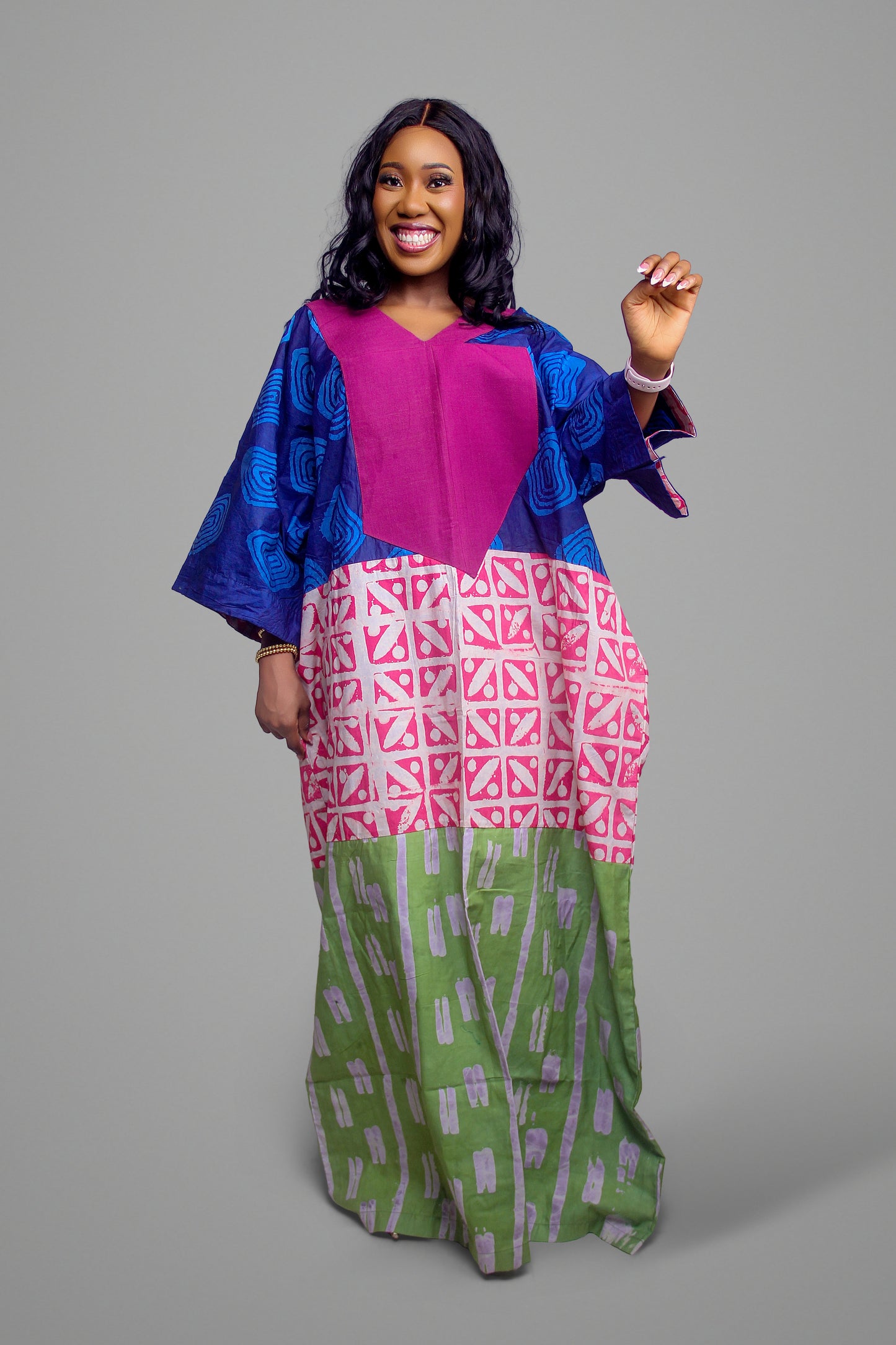 Kaftan dress detailed with a magenta chest panel, blue geometric shoulders, and a green-pink patterned skirt.