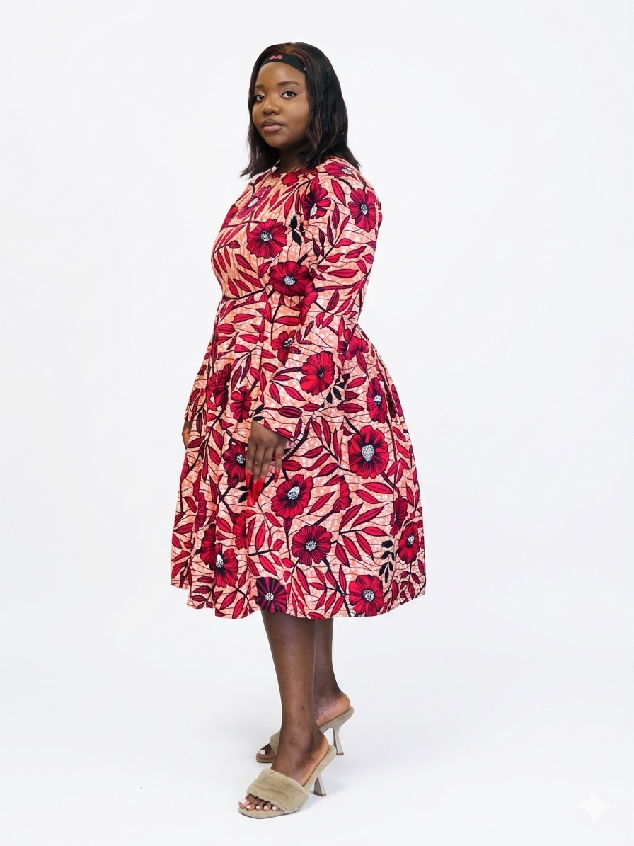 Side view of a midi dress in a red floral African print fabric with a full skirt.