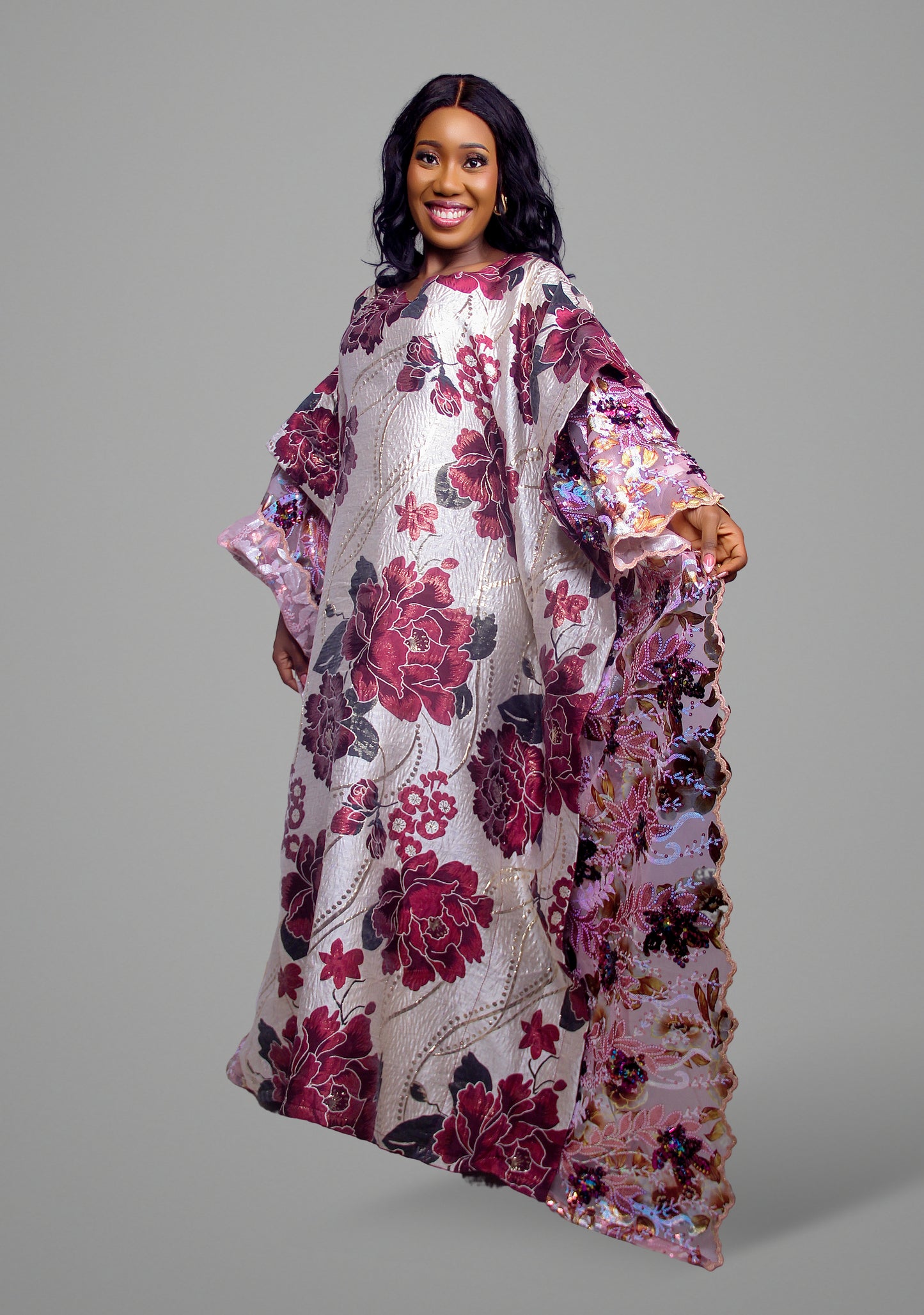 A full-length floral print kaftan dress with detailed embroidery on the sleeves.