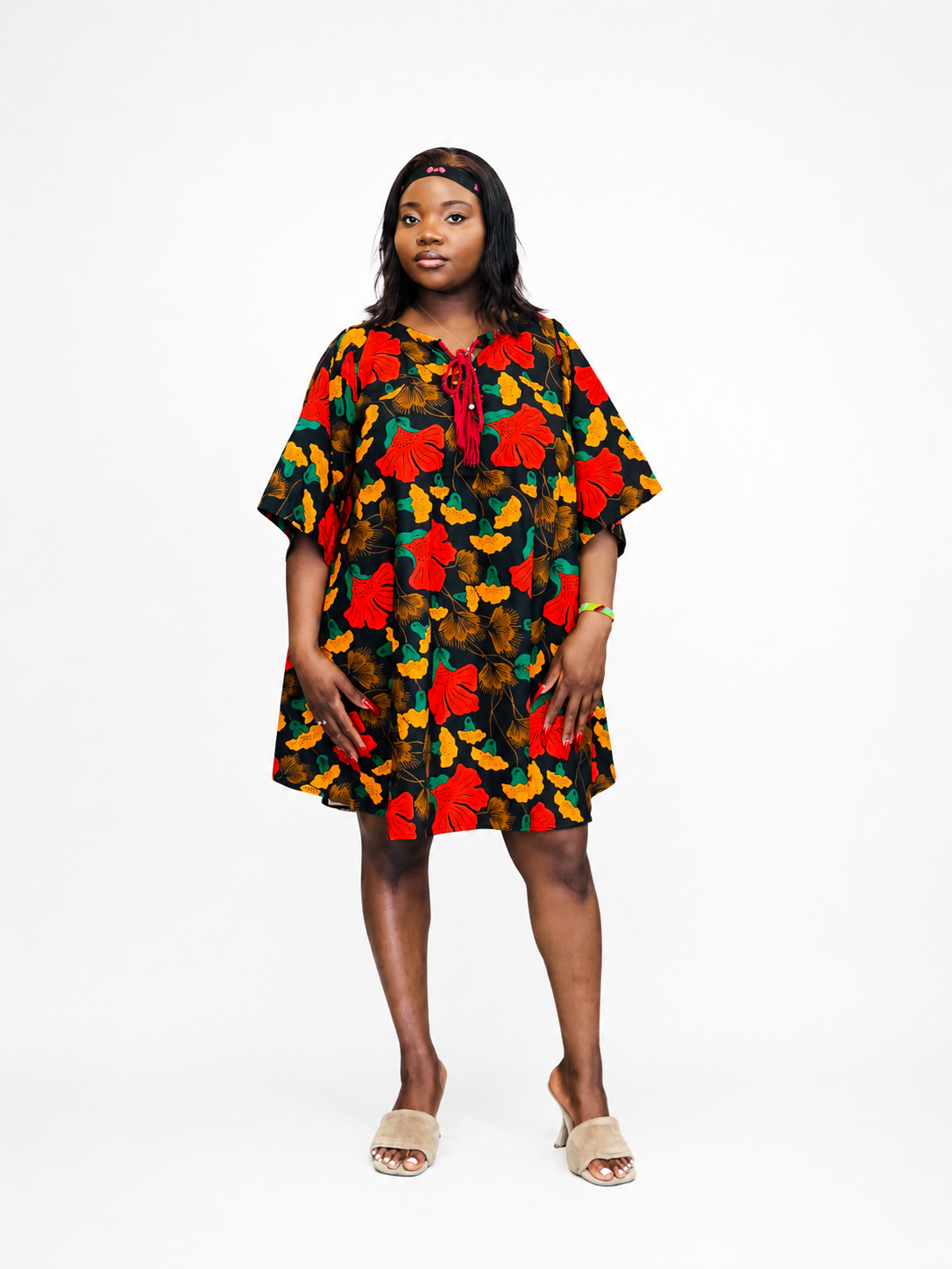 Kaftan mini dress in black with red and yellow floral print and a red lace-up neckline