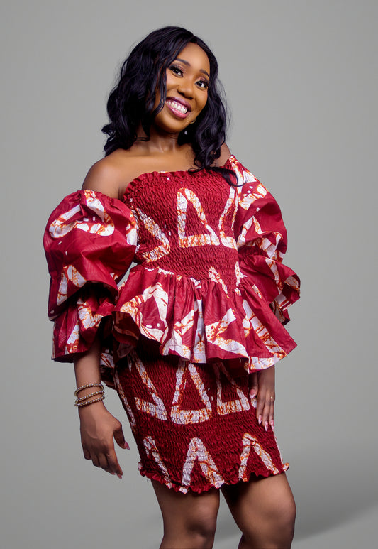 Smocked off-the-shoulder mini dress in a bold red and white geometric batik print