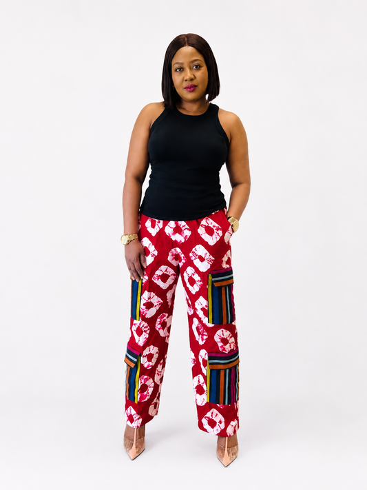 Front view of red tie-dye wide-leg cargo pants with striped side pockets.