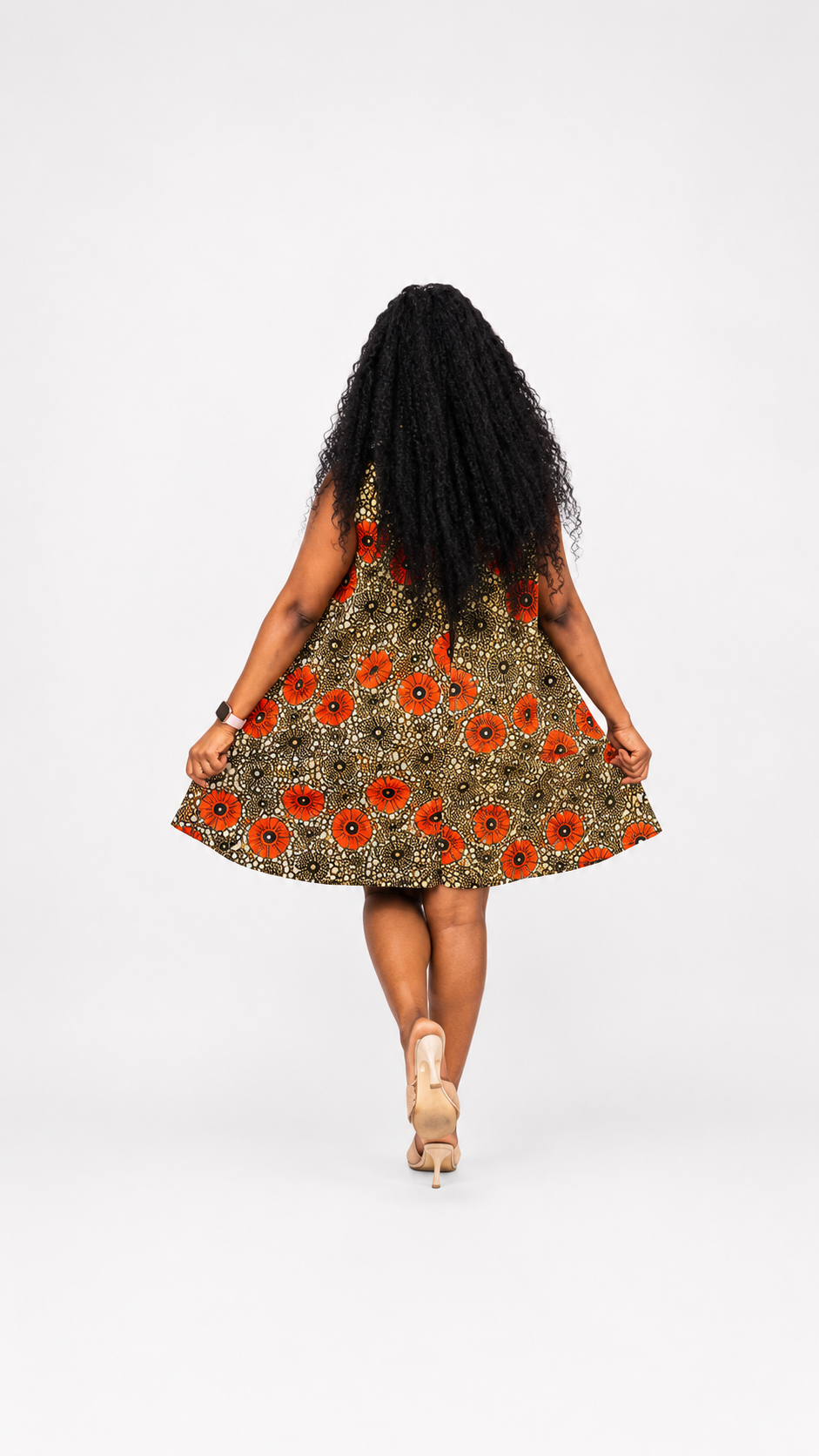 Rear view of the orange and black floral-patterned A-line mini dress.