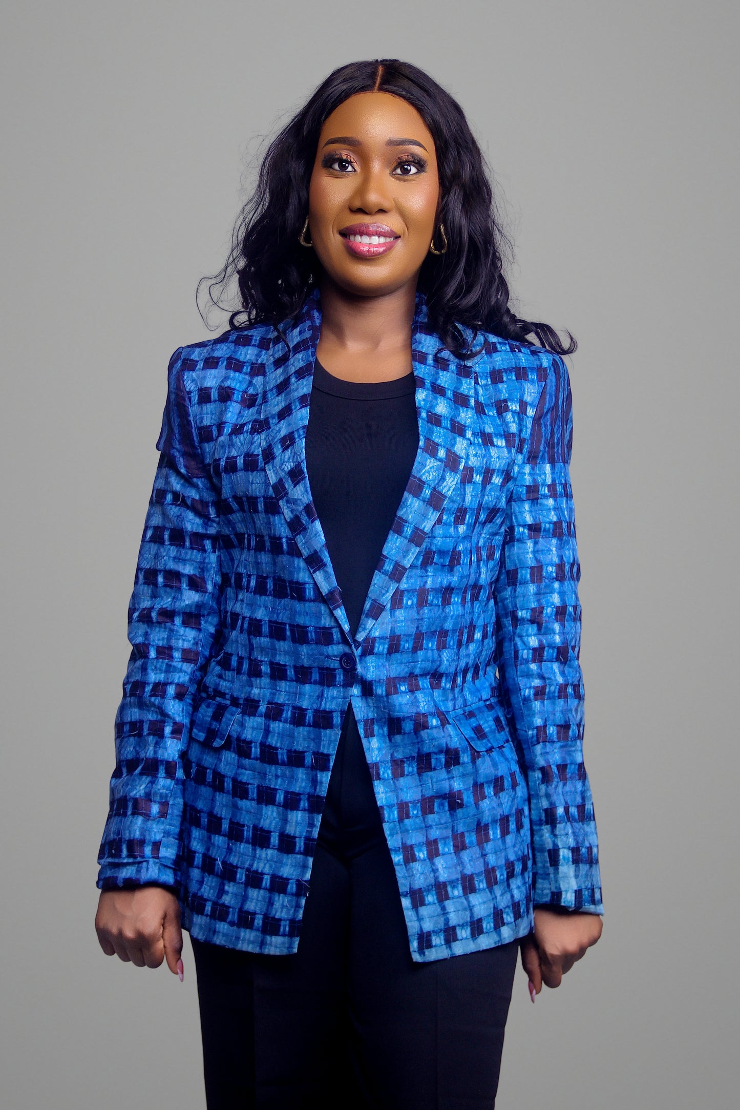 Frontal view of a woman wearing a tailored blue geometric print blazer with single-button closure