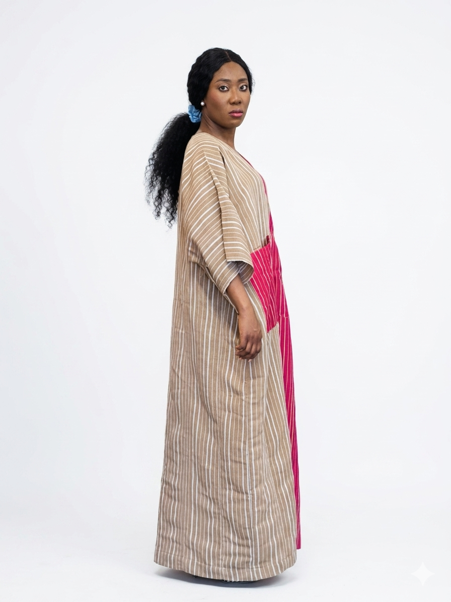 Side profile of the striped kaftan dress demonstrating its structured fit