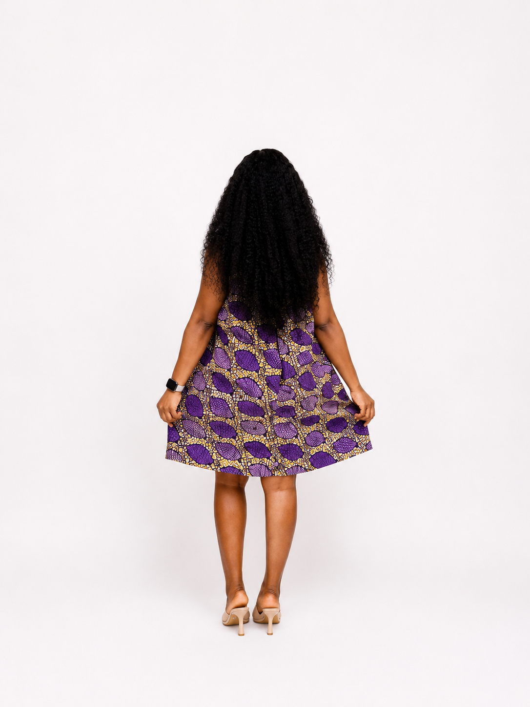 Rear view of the purple and yellow A-line mini dress showing the flared hem and print detail.